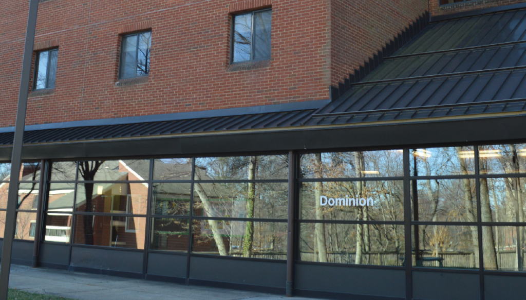 Exterior view of Dominion Hall entrance at George Mason University, a first-year residence hall