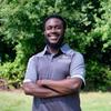 Kayon Johnson in a grey mason polo smiling